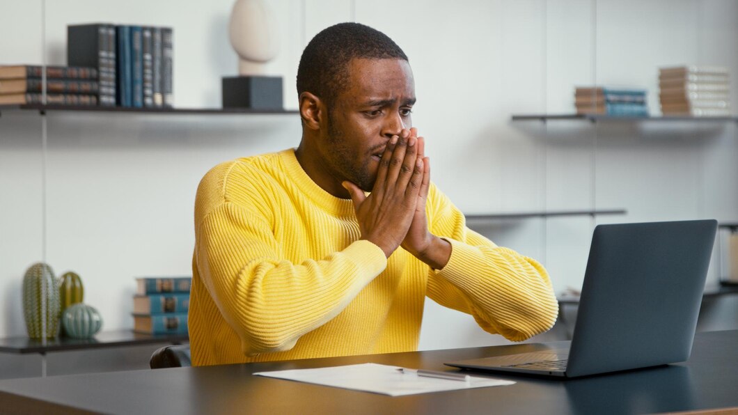 depressed-man-looks-laptop